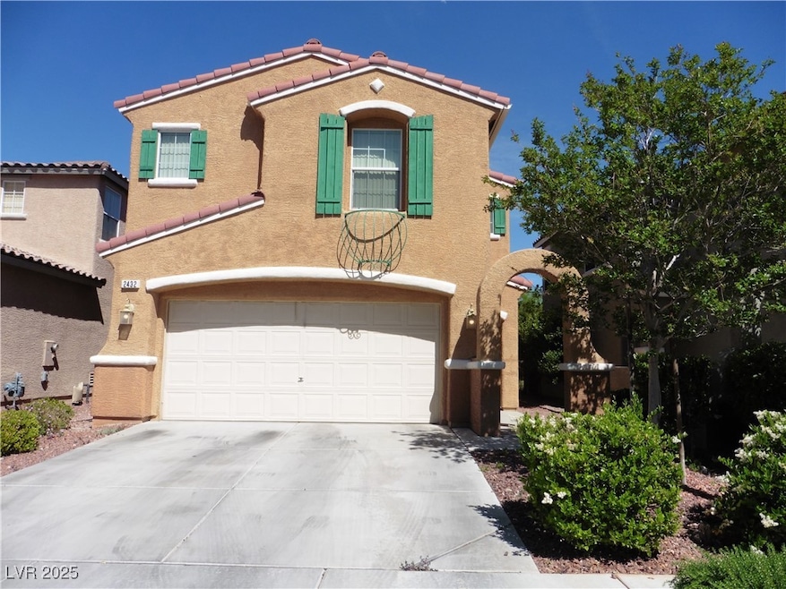 View of front of property with driveway, a garage,