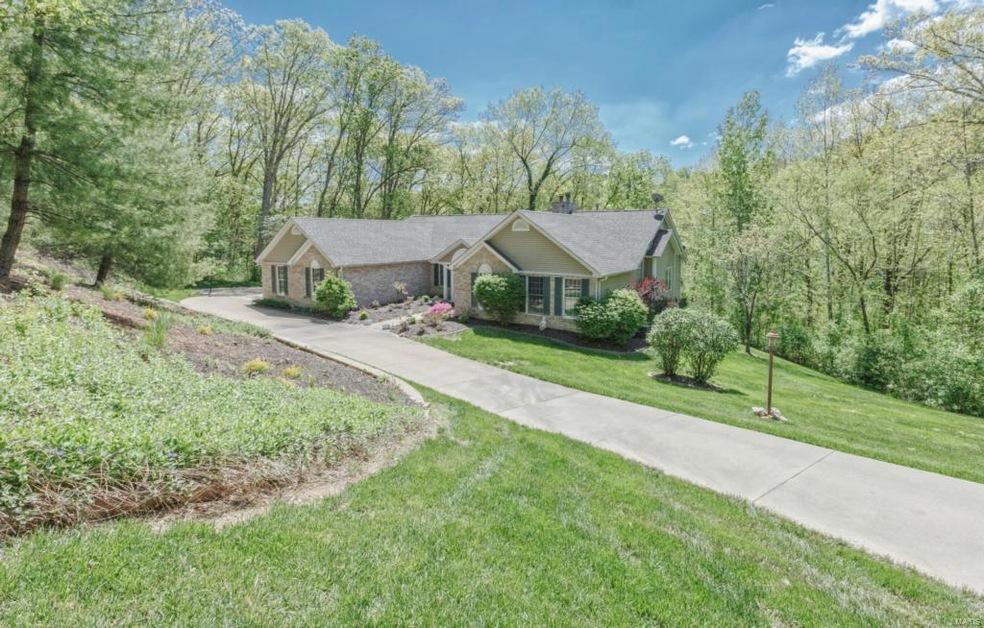 Atrium ranch on 3 heavily wooded acres, brick fron