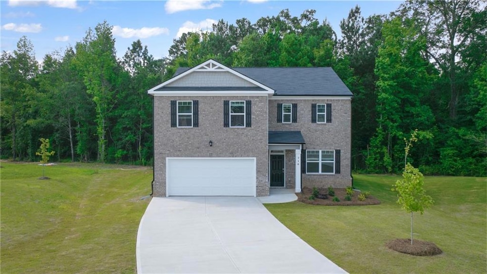 View of front facade with a garage and a front law