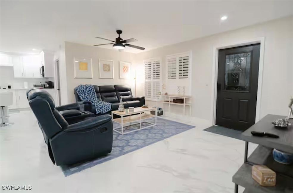 Living area featuring ceiling fan and recessed lig