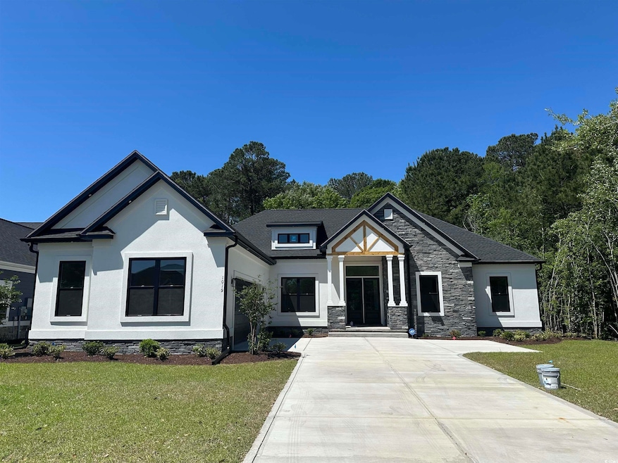 View of front of property featuring stone siding, 