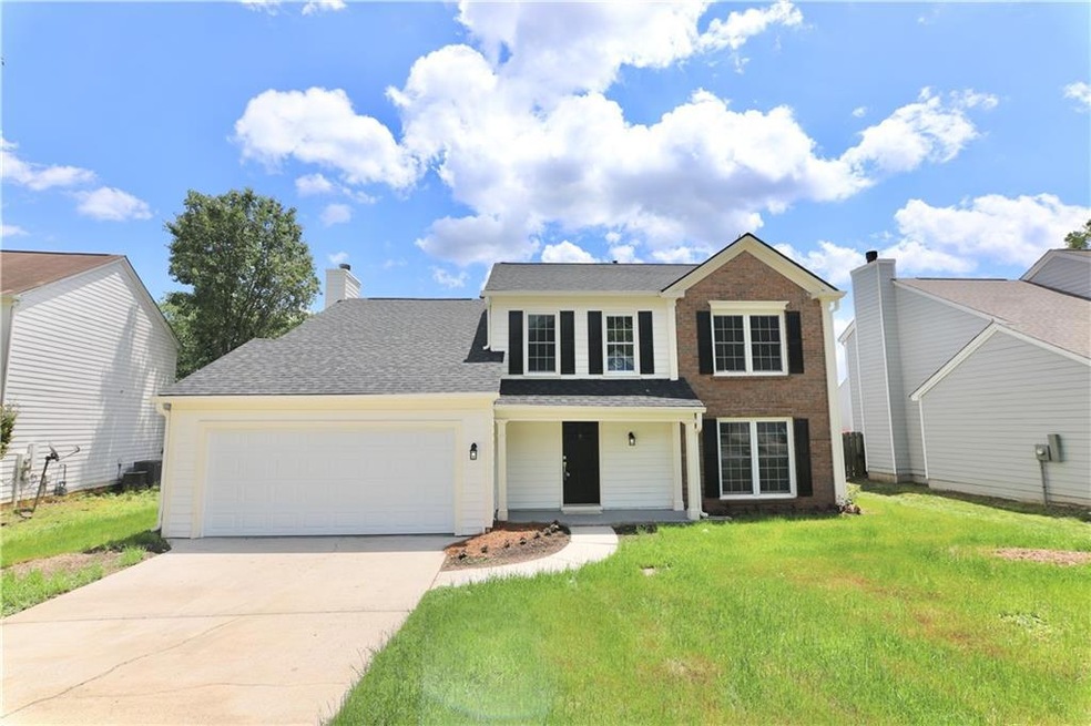 View of front of property with a garage and a fron