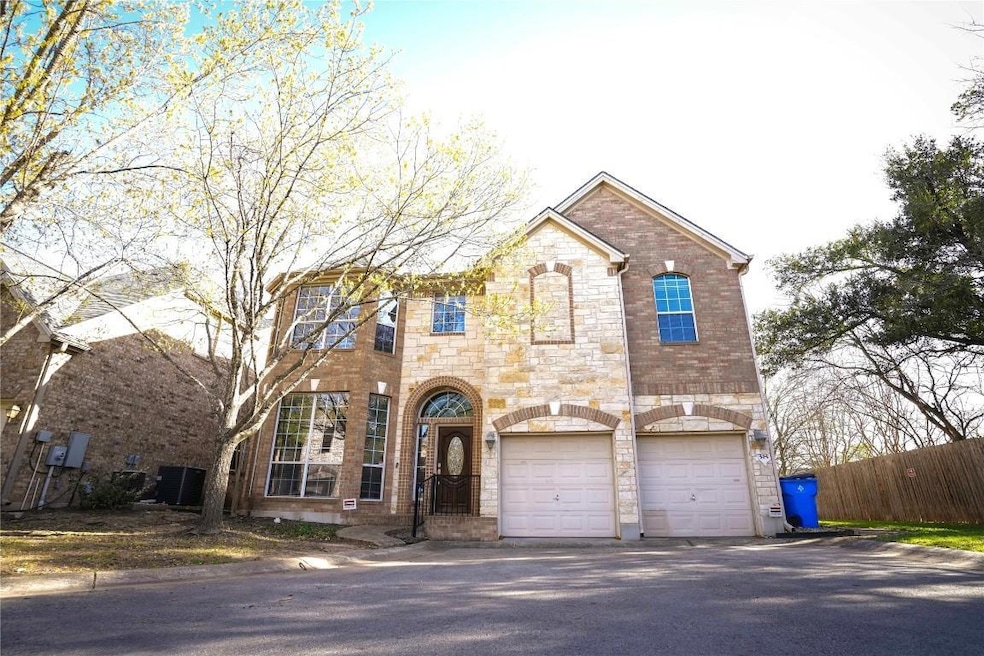 View of front of house with a garage, stone sidin