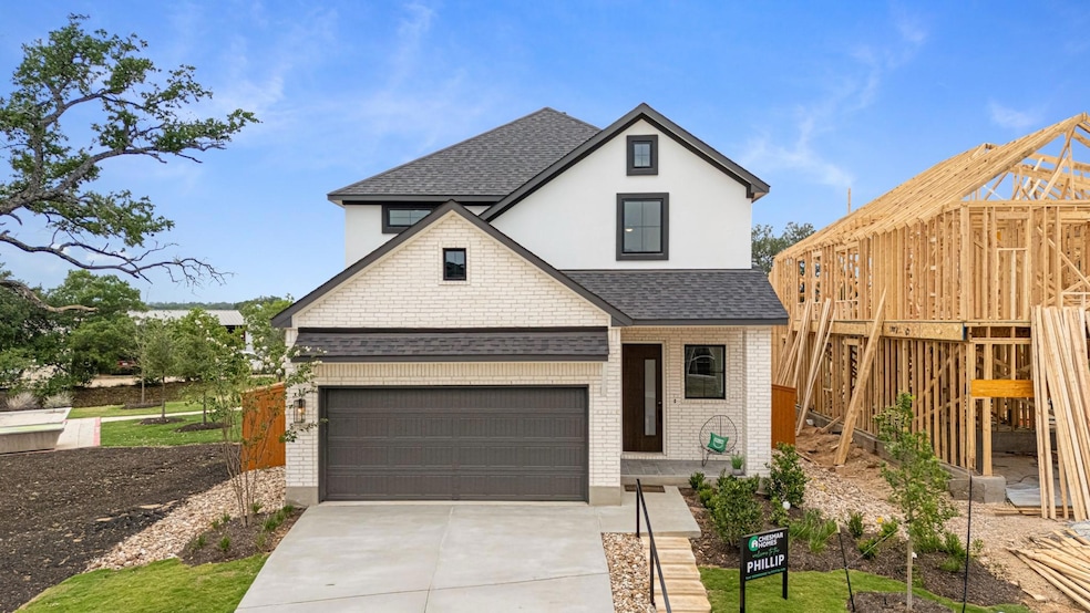 View of front of home featuring a shingled roof, 