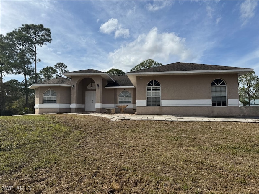 View of front of house with stucco siding and a fr