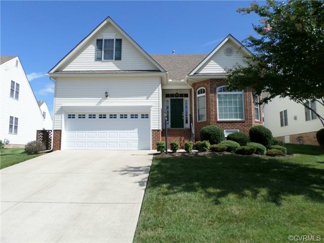 Front of home with brick detail and large driveway