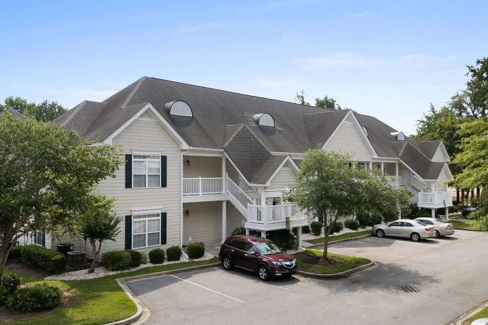 View of property featuring uncovered parking