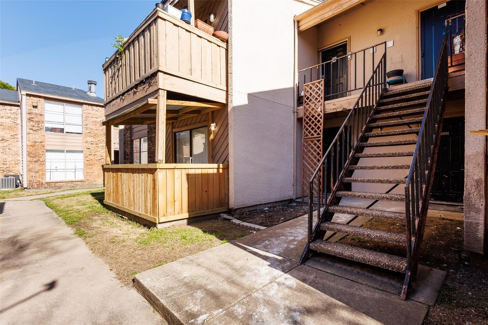 View of property exterior with stairway and stucco