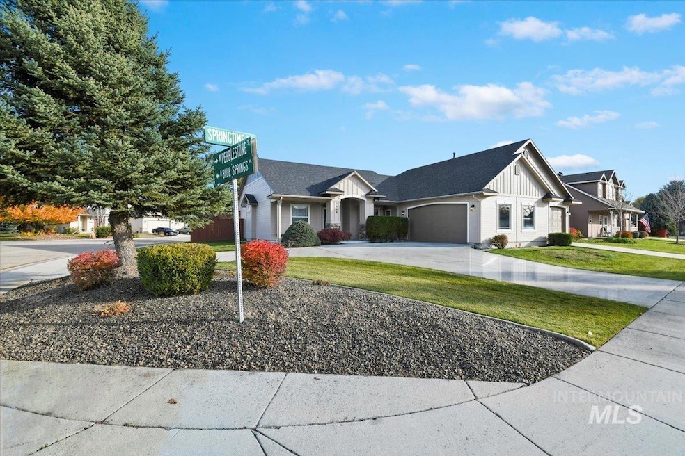 View of front of house with board and batten siding, driveway, a front yard, and a garage