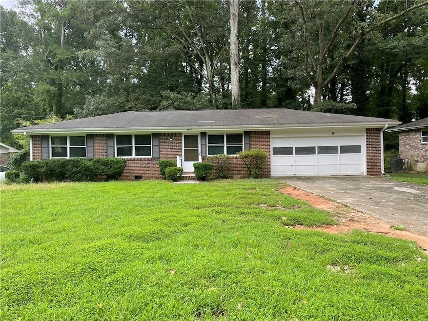 Ranch-style house with central AC unit, a garage, 