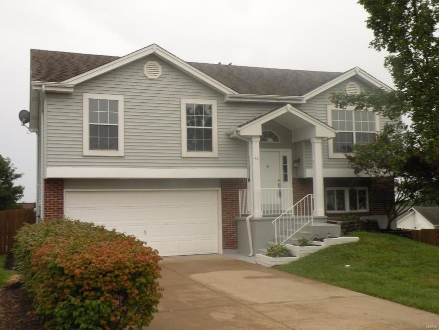 Split-level with siding and brick on front exterio