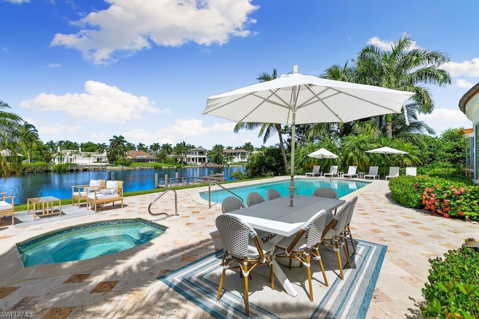 View of swimming pool with a water view, a patio, 