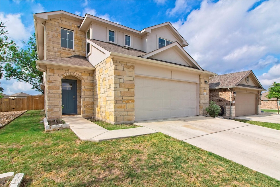 Traditional-style house featuring stone siding, a