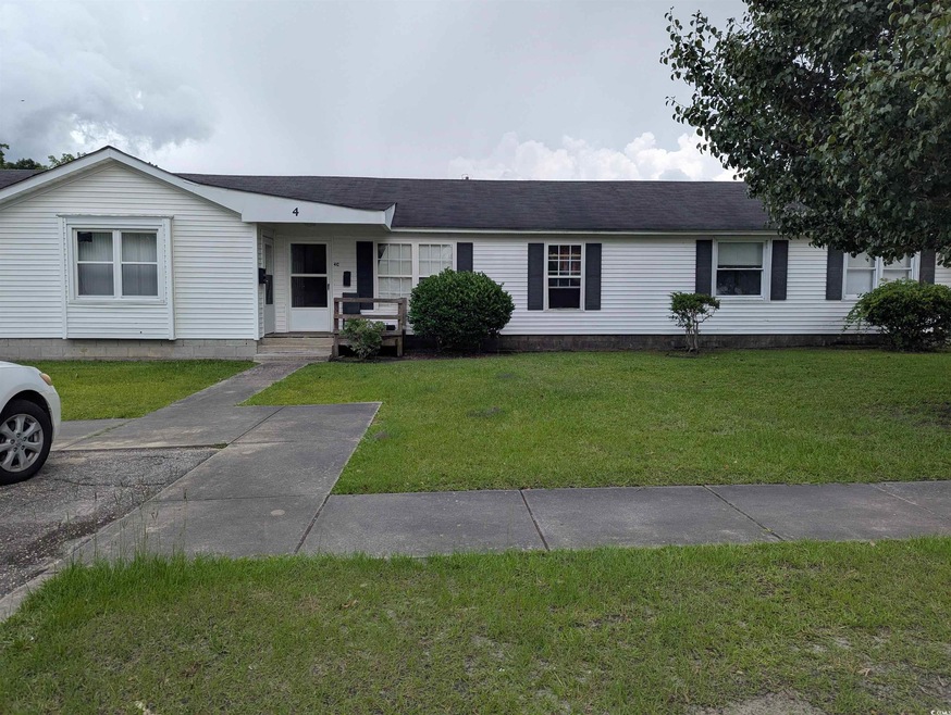 Single story home featuring a front yard and a shingled roof