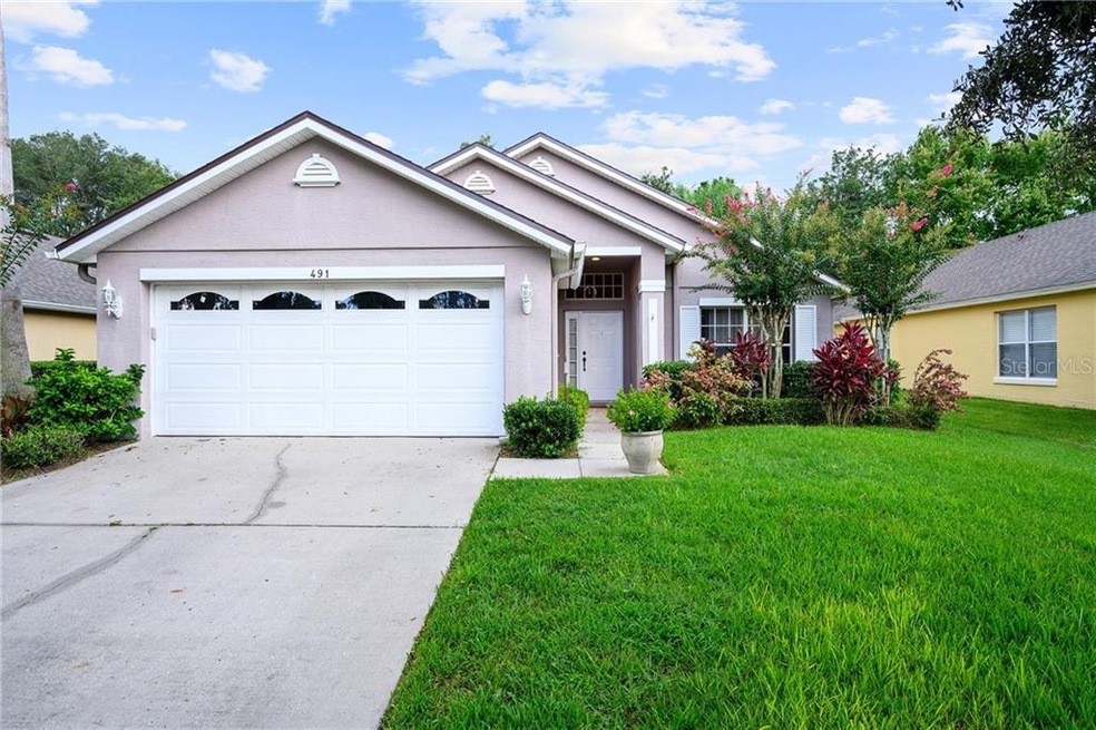 Mature landscaping, lush green lawn and an ample t