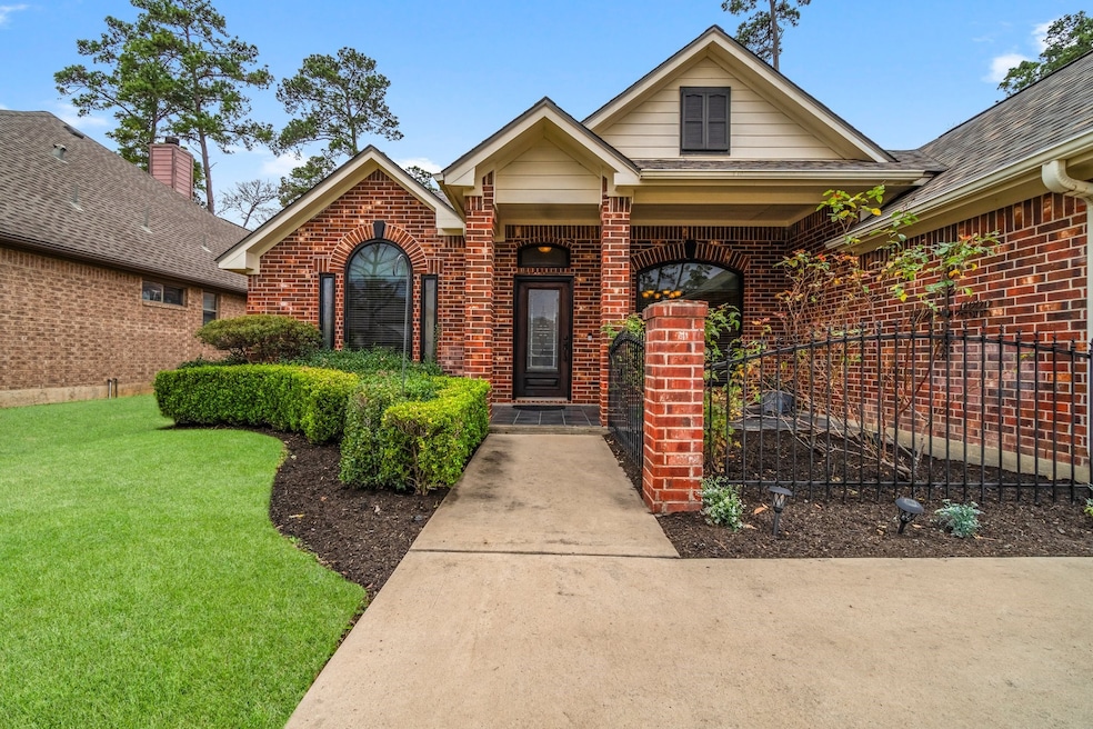 This charming brick home features a welcoming front porch, a spacious two-car garage, and a well-maintained lawn. It is nestled in a serene neighborhood with mature trees, offering a peaceful setting.