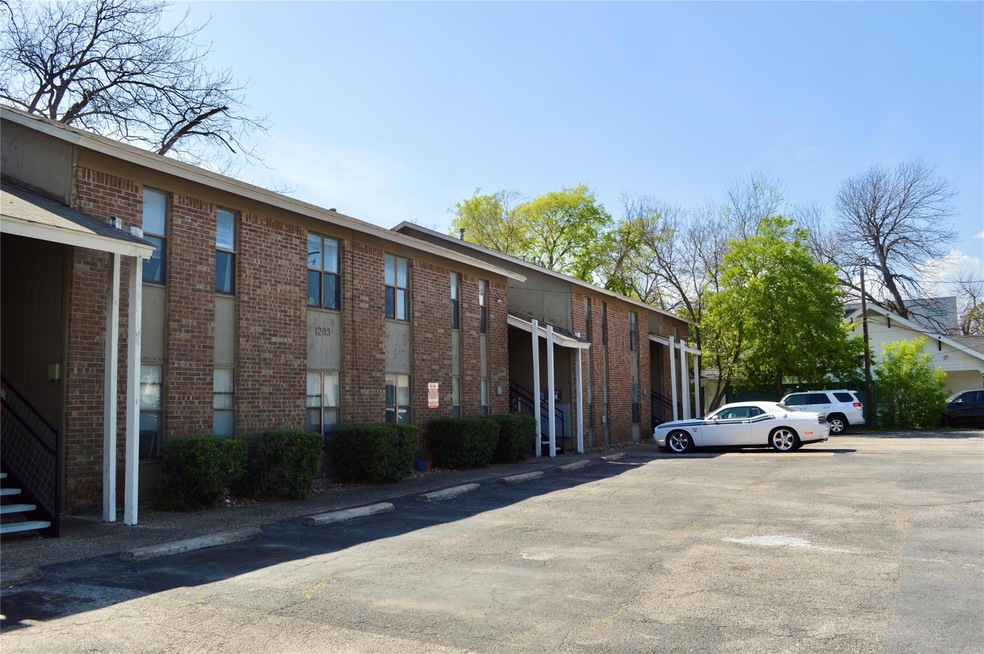 View of property featuring uncovered parking