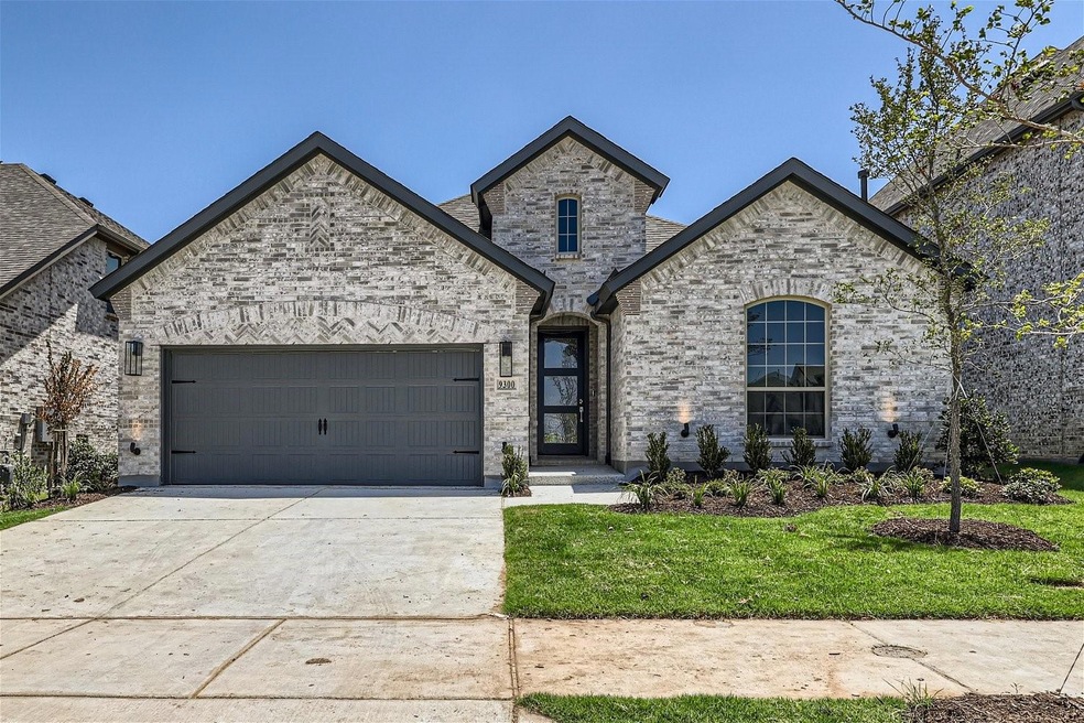 French country style house with a garage and a front lawn