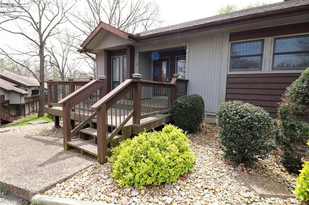 The perfect end unit tucked between mature trees & golf course views.