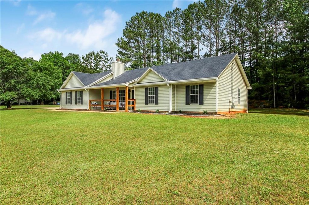 View of front facade with a front lawn, a chimney,