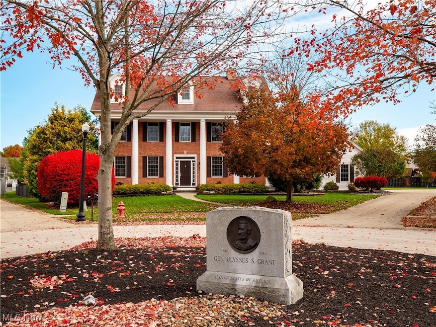View of front facade featuring covered porch, brick siding, and a front lawn