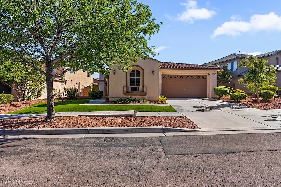 Mediterranean / spanish-style house featuring stucco siding, concrete driveway, a tiled roof, and a garage