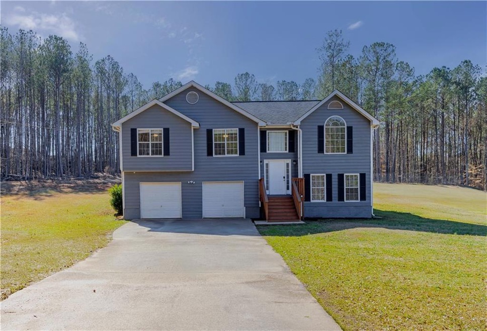 Split foyer home with a front lawn, driveway, and 