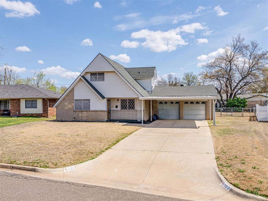 View of front facade featuring fence, driveway, a 