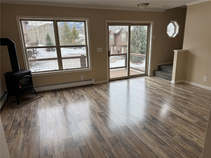 Unfurnished living room featuring wood-type floori