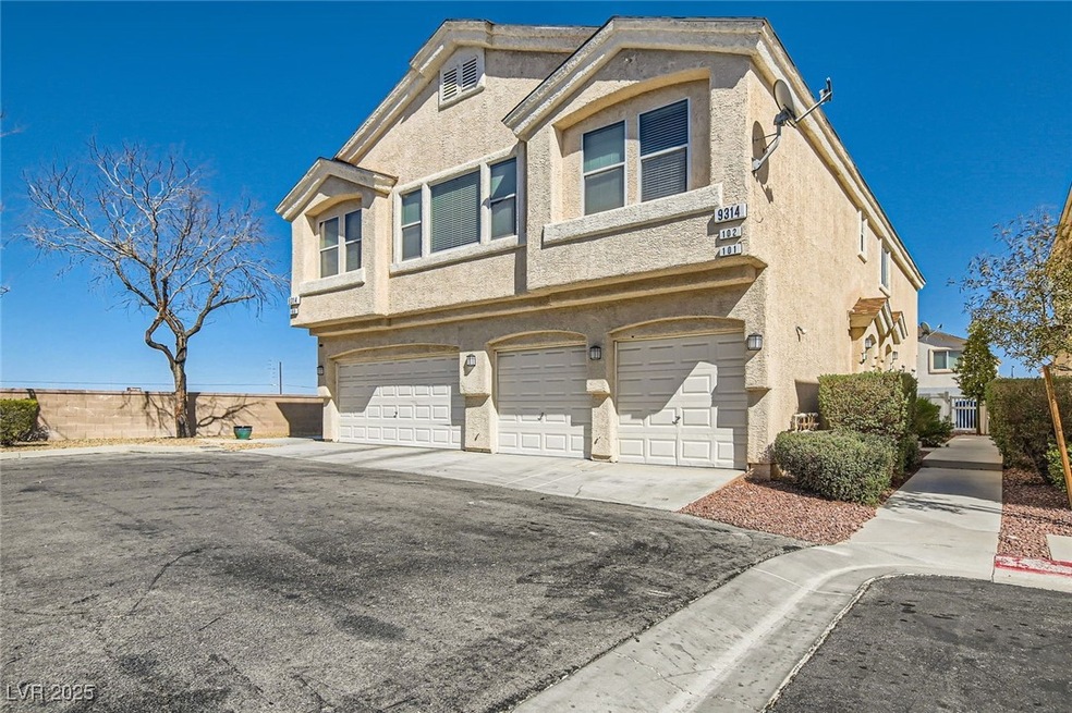View of front facade featuring stucco siding, driv