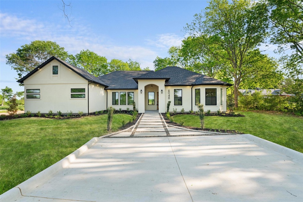 View of front facade with a front yard, roof with 