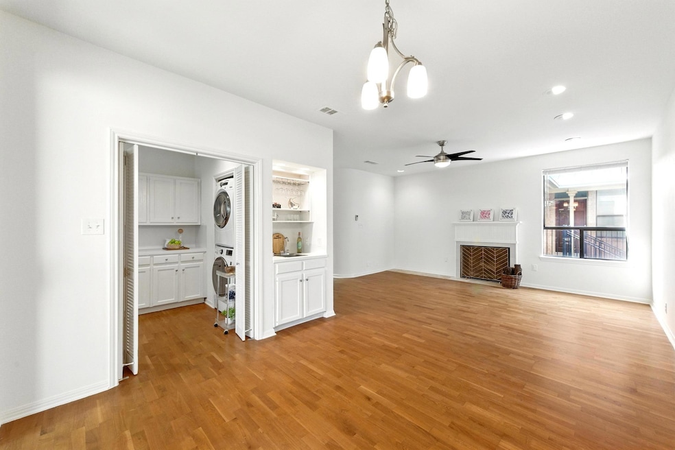 Unfurnished living room with a ceiling fan, stack
