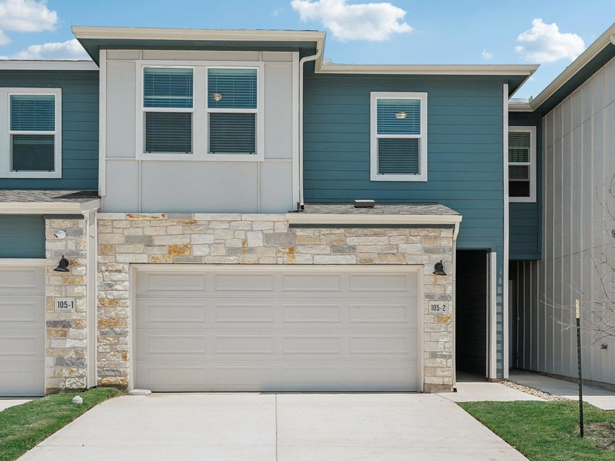 Townhome / multi-family property featuring stone 