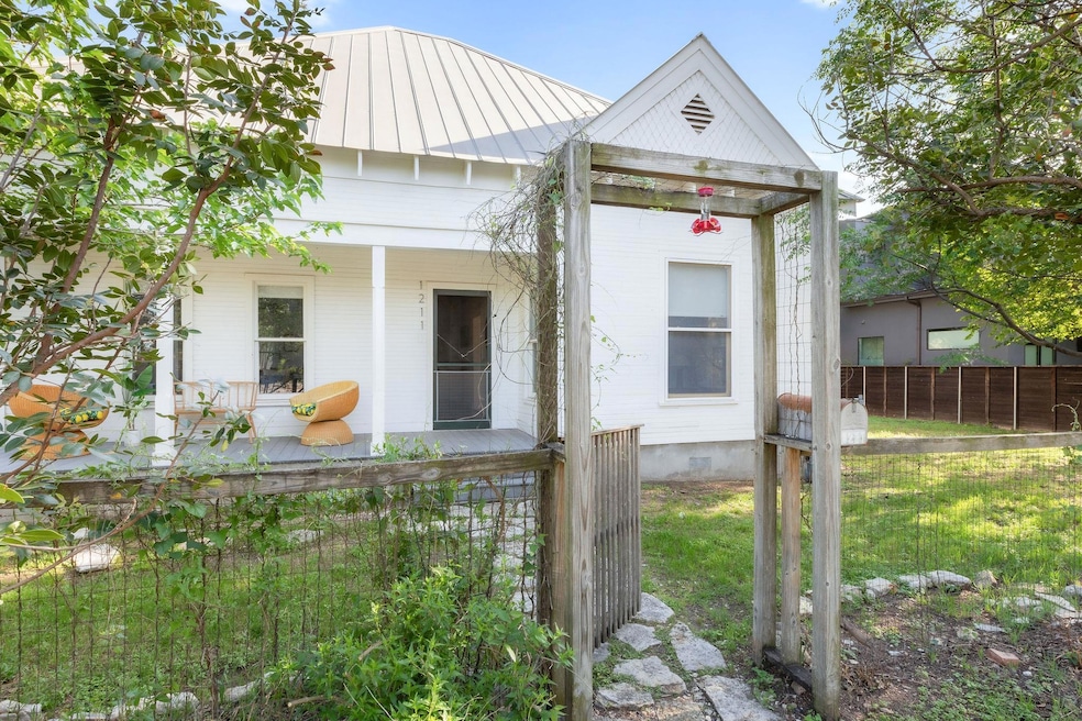 View of front facade with covered porch, metal ro