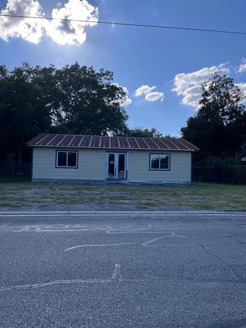 View of front of property with a front yard and m