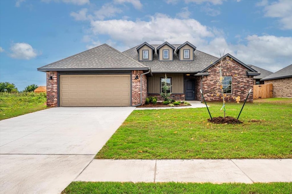 View of front of property featuring covered porch, concrete driveway, a garage, a shingled roof, and a front lawn