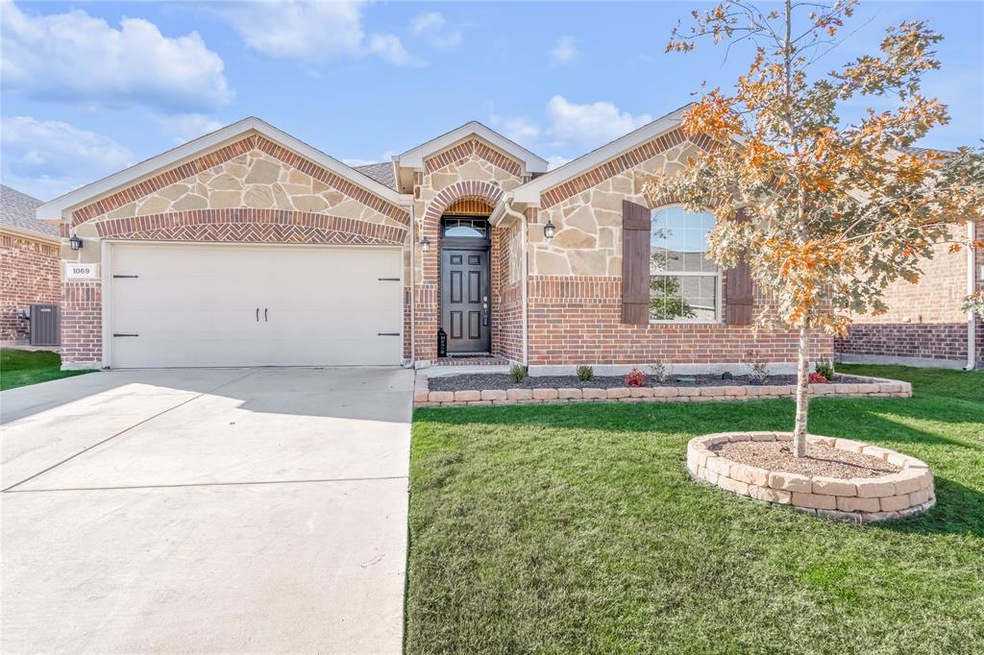 Brick with stone elevation. Lawn with sprinkler system.