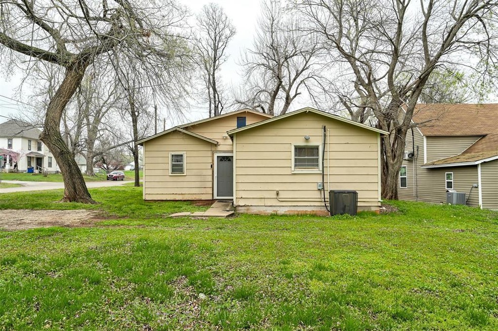 Rear view of property featuring central AC unit an