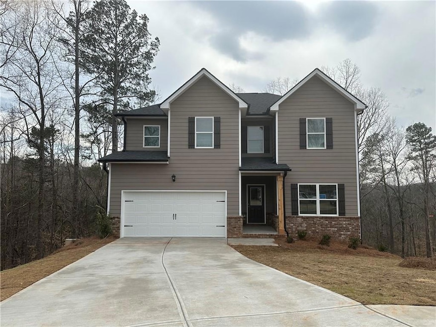 Craftsman-style house featuring concrete driveway, brick siding, and an attached garage