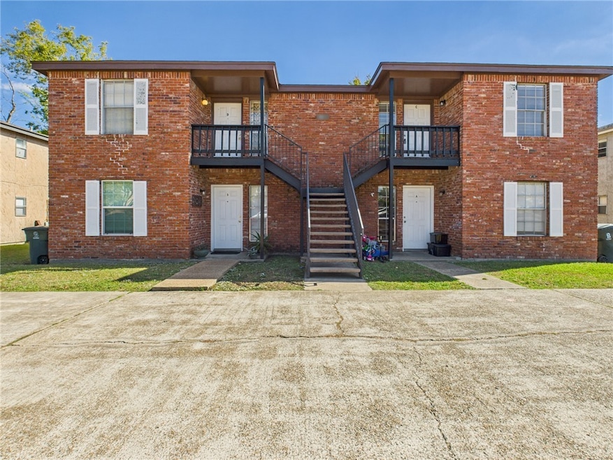 View of property featuring stairway