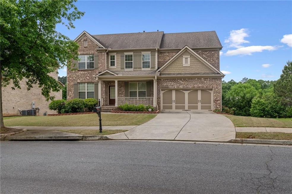View of front of property with a porch, roof with 