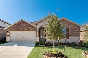 View of front  featuring a garage and a front lawn