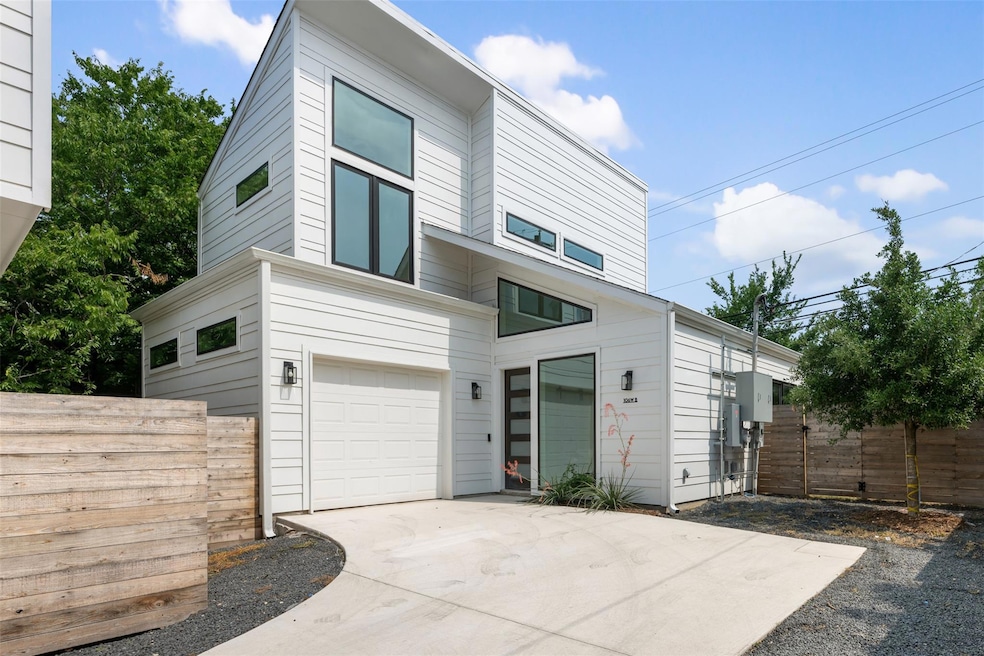 Contemporary home with driveway and an attached g