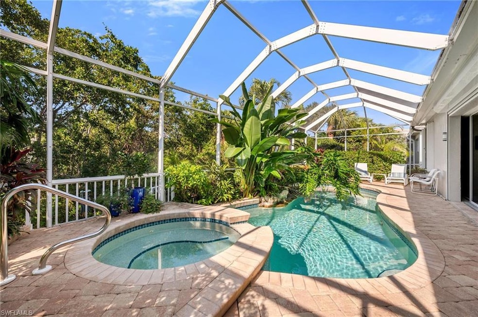 Screened-in pool and spa with paver surrounds.  Th