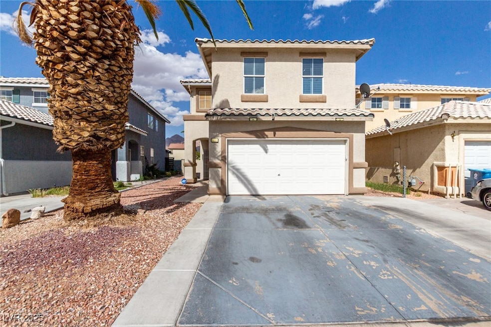 View of front of home with stucco siding, a tiled