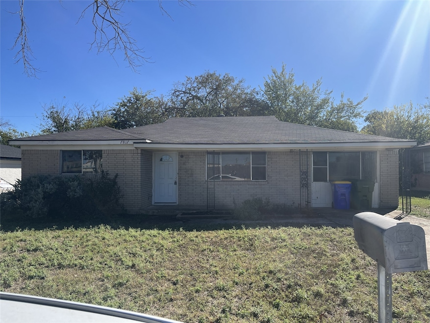 Single story home with brick siding and a front lawn