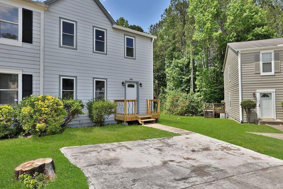 Rear view of house featuring a lawn, a patio, and 