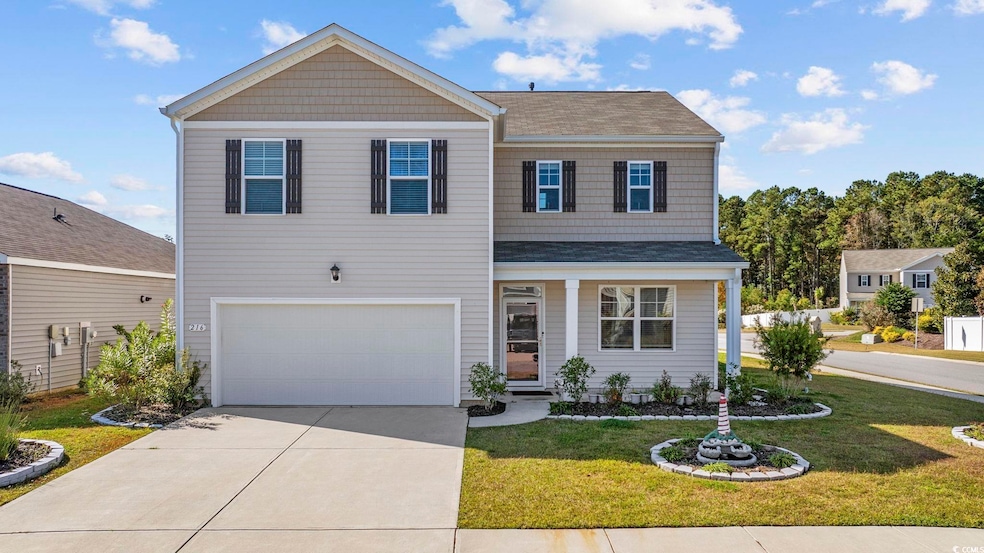 View of front of property with a front yard, a porch, concrete driveway, an attached garage, and a shingled roof
