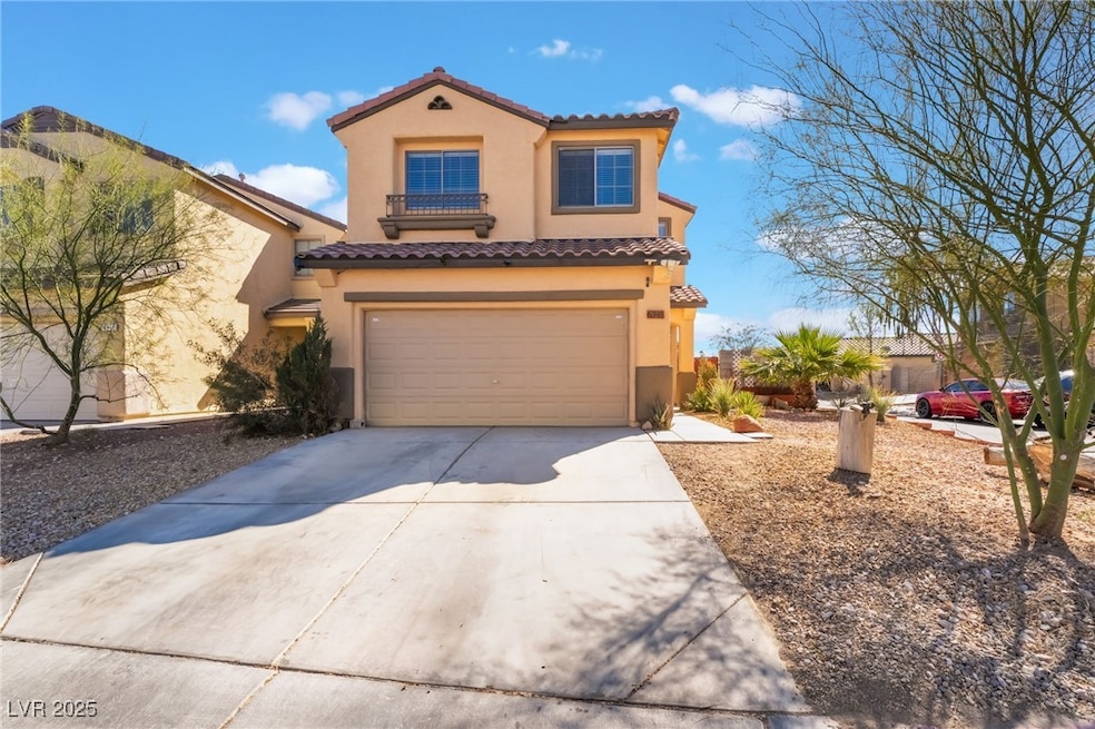 Mediterranean / spanish home with a garage, drivew