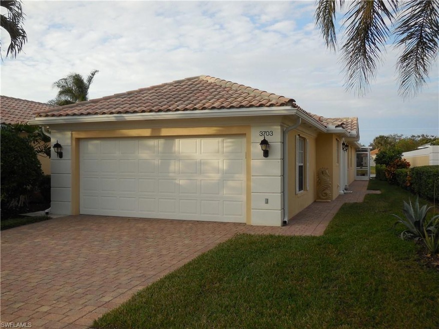 View of home's exterior with a garage and a lawn